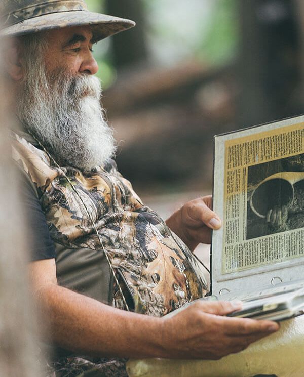 Ken Capling reviewing his news article about wining world champion moose call