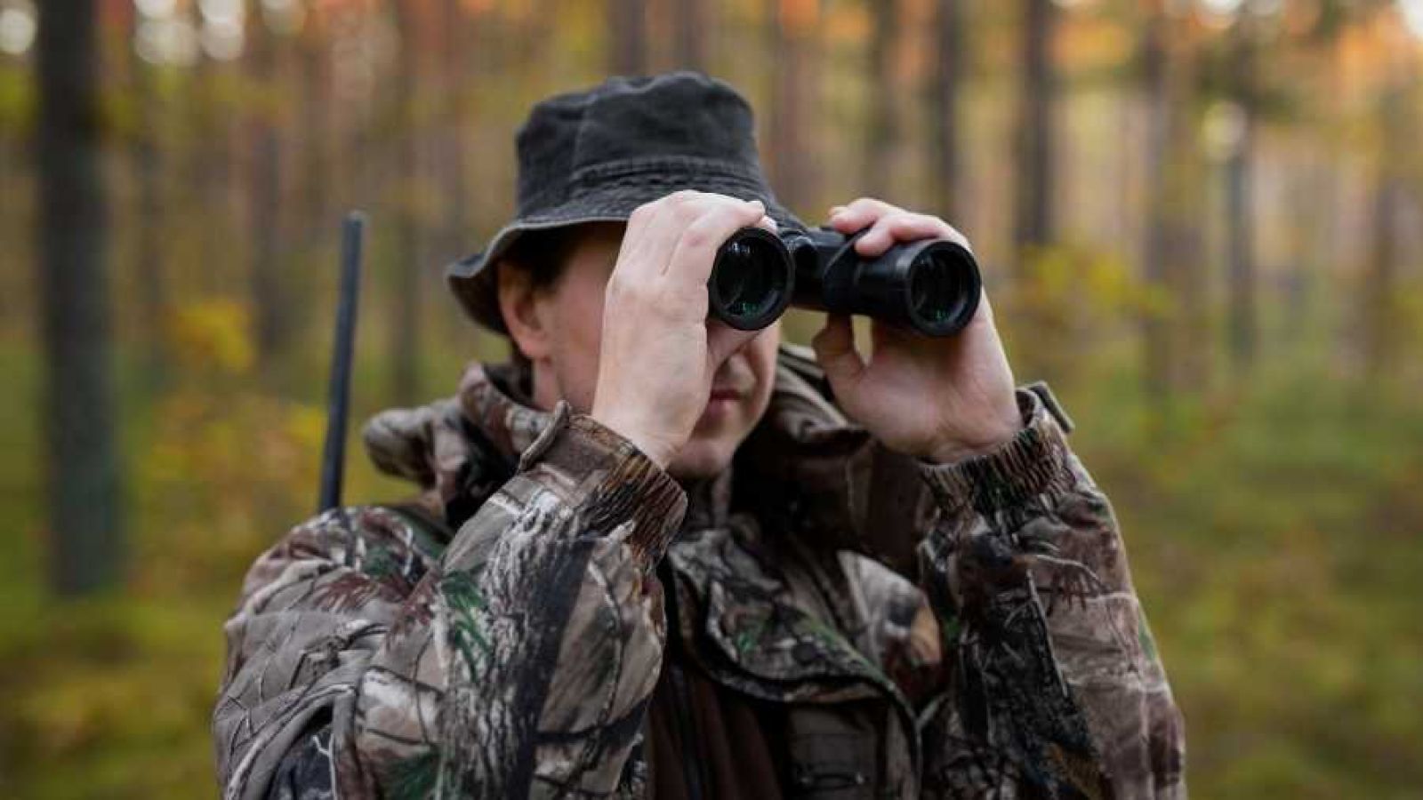 Hunter looking through binoculars