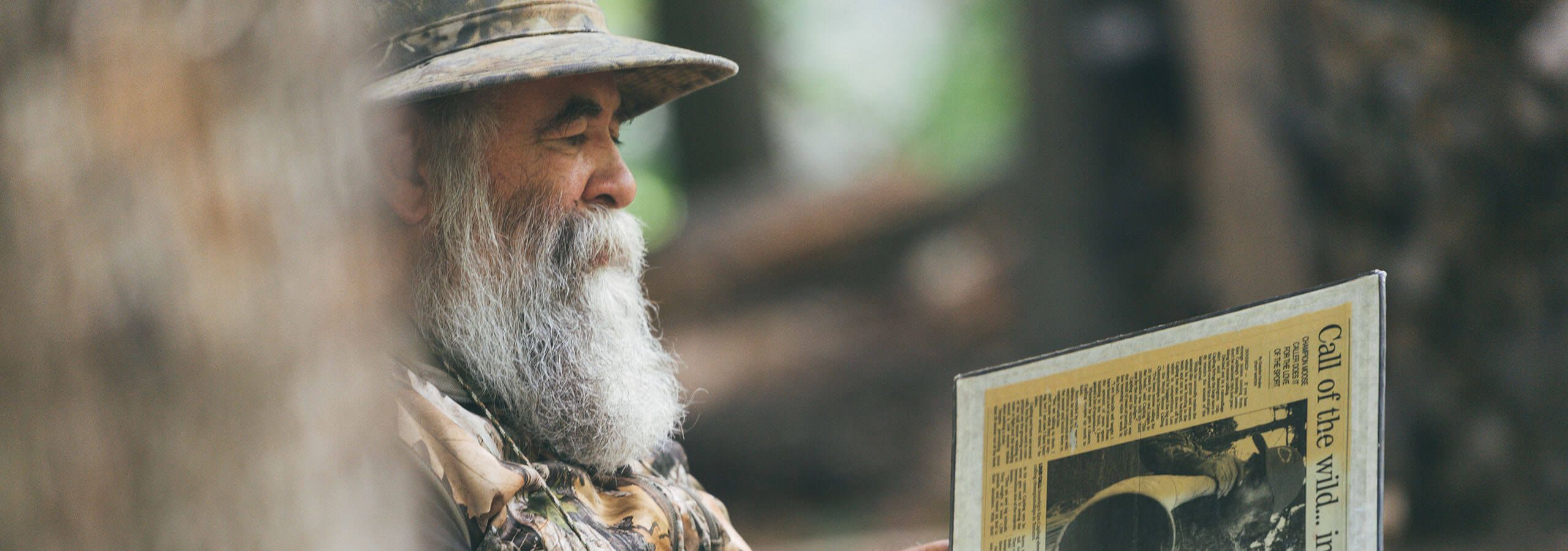 Ken Capling reviewing his news article about wining world champion moose call