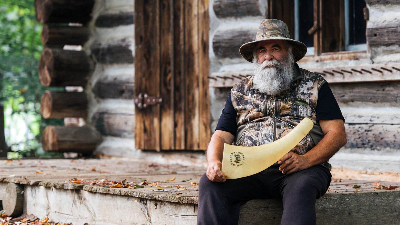 Ken Capling on the front porch of hunting cabin with a KC Moose Call